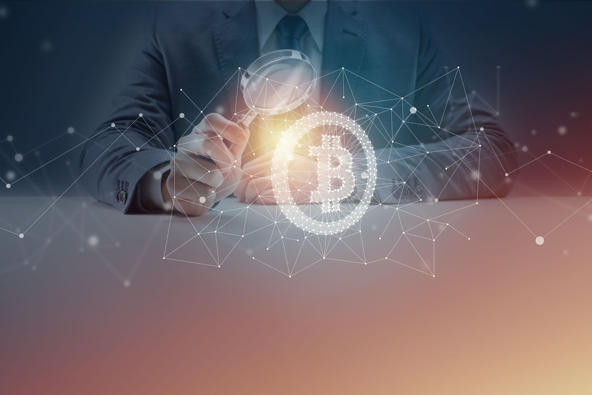 Businessman at Desk Looking Through Magnifying Glass at Bitcoin Symbol